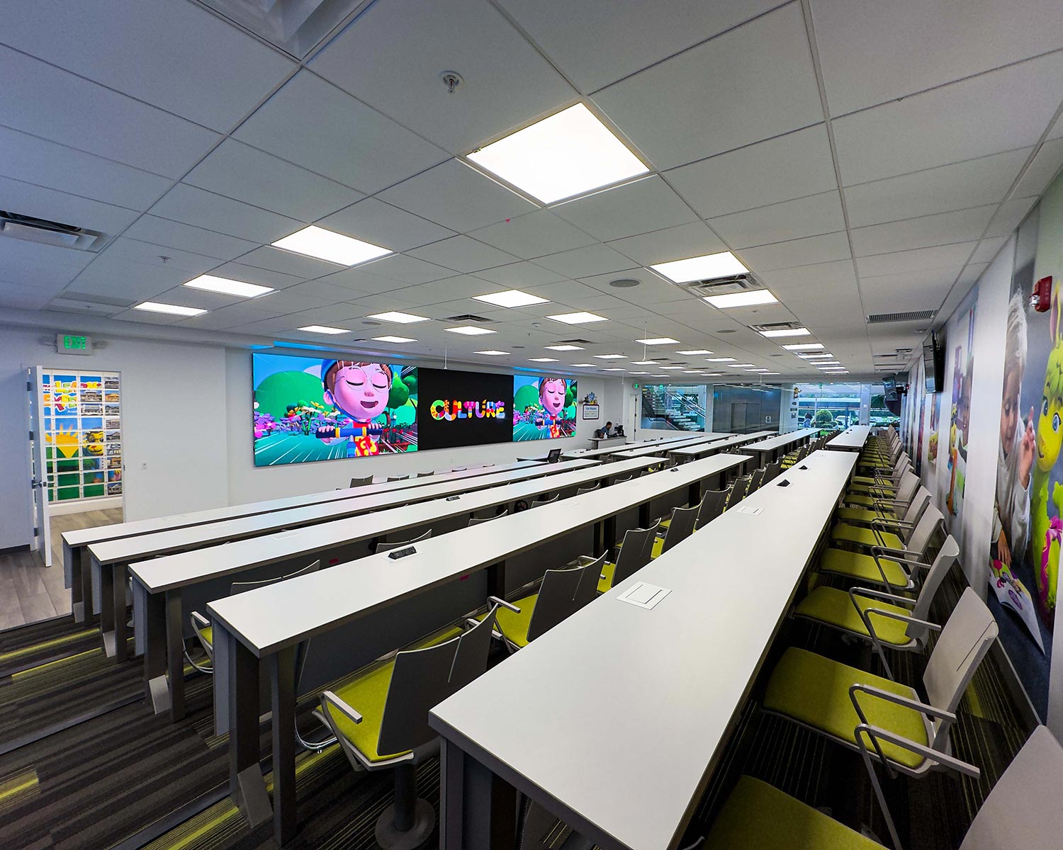 Modern lecture room with multiple MicroLED screens displaying colorful educational visuals