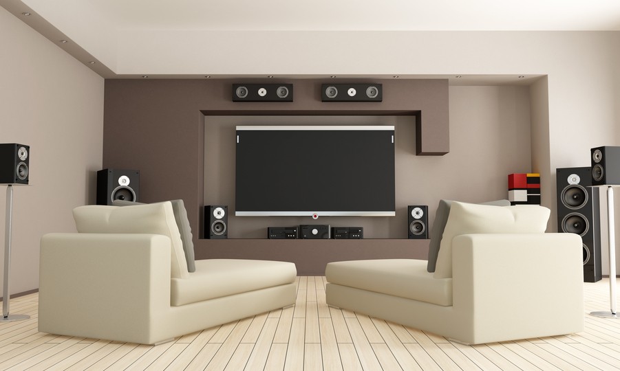 Image is of a living room with an elaborate surround sound setup.